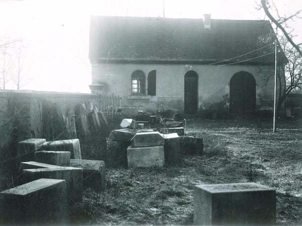 Taharahaus mit aufgeschlichteten Grabsteinen 1940er Jahre